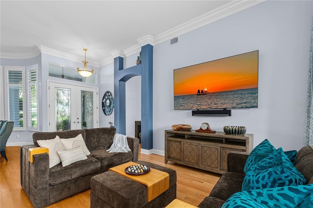801 Arbor Glen Ct, Ormond Beach, FL 32174 - living room with crown molding, arched walkways, wood finished floors, and french doors