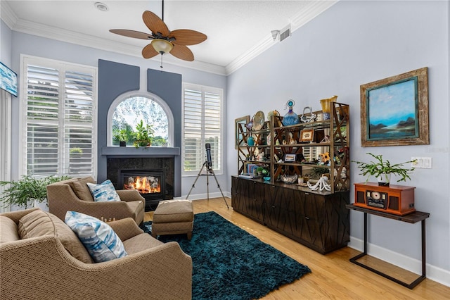 801 Arbor Glen Ct, Ormond Beach, FL 32174 - living room with a fireplace, a ceiling fan, light wood finished floors, and crown molding