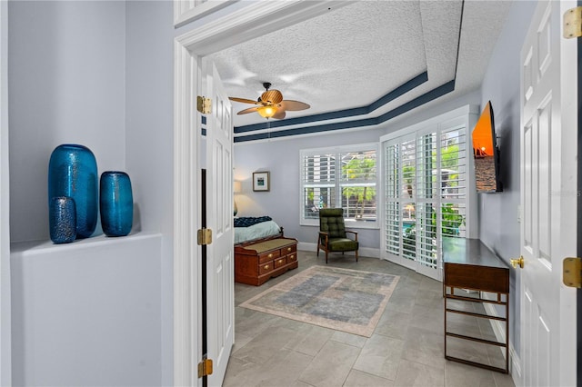 801 Arbor Glen Ct, Ormond Beach, FL 32174 - bedroom featuring a textured ceiling, ceiling fan, and a raised ceiling