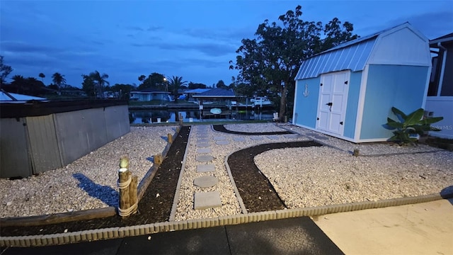 3510 Magnolia Way, Punta Gorda, FL 33950 - yard at dusk with a shed and a water view
