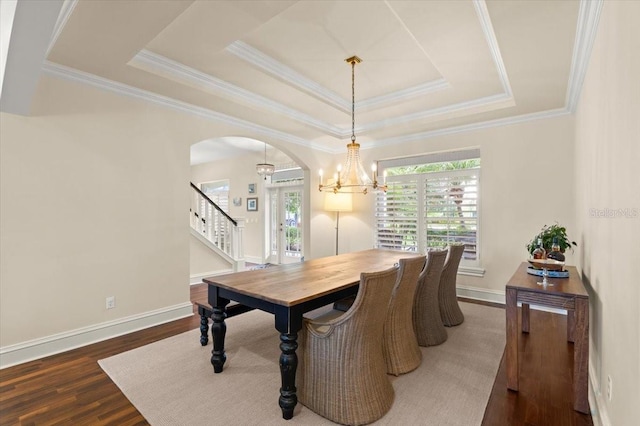 113 Neptune Ave, Ormond Beach, FL 32176 - dining space with a chandelier, healthy amount of natural light, arched walkways, wood finished floors, and ornamental molding