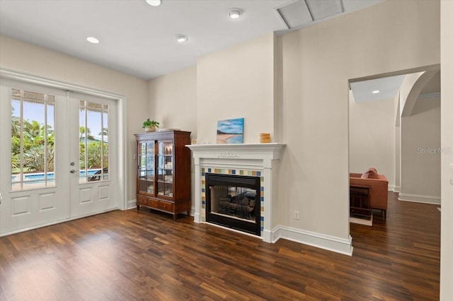 113 Neptune Ave, Ormond Beach, FL 32176 - living room with wood finished floors, arched walkways, a tile fireplace, french doors, and recessed lighting