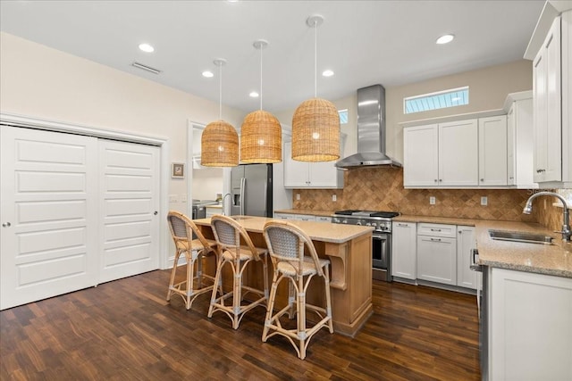 113 Neptune Ave, Ormond Beach, FL 32176 - kitchen with appliances with stainless steel finishes, wall chimney exhaust hood, a center island, dark wood-type flooring, and recessed lighting