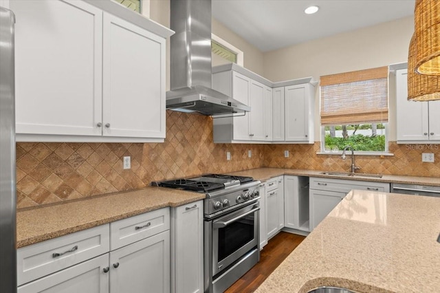113 Neptune Ave, Ormond Beach, FL 32176 - kitchen featuring high end stainless steel range, wall chimney range hood, dark wood-style floors, white cabinetry, and recessed lighting