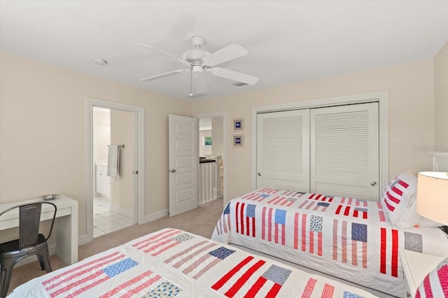 113 Neptune Ave, Ormond Beach, FL 32176 - bedroom featuring a closet, light carpet, ceiling fan, and ensuite bath