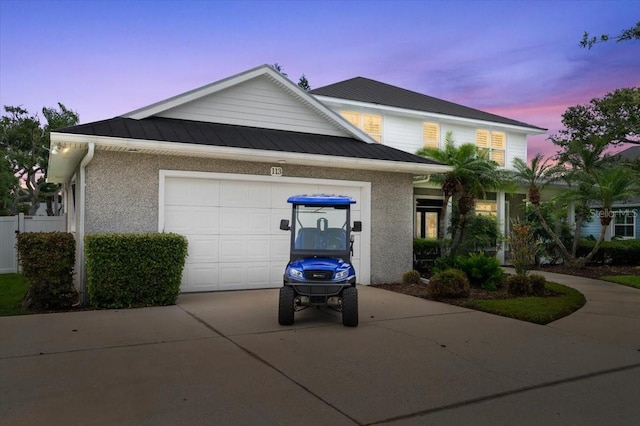 113 Neptune Ave, Ormond Beach, FL 32176 - view of front of home with concrete driveway, a garage, stucco siding, and a metal roof