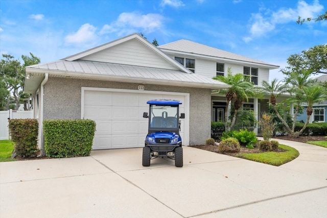 113 Neptune Ave, Ormond Beach, FL 32176 - view of front of property featuring concrete driveway, a garage, stucco siding, and a metal roof