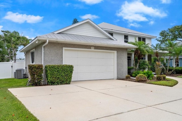 113 Neptune Ave, Ormond Beach, FL 32176 - view of front of house with driveway, a garage, stucco siding, and a metal roof