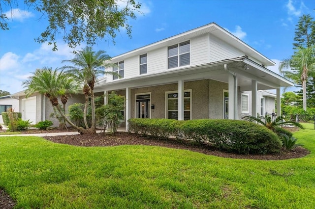 113 Neptune Ave, Ormond Beach, FL 32176 - view of front of house featuring a front yard, a garage, a porch, and stucco siding