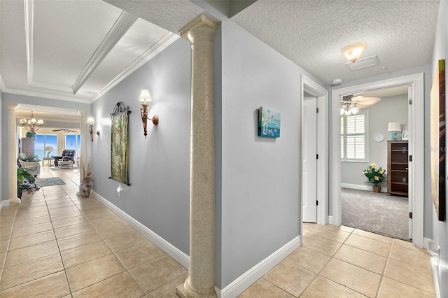 2901 S Atlantic Ave Unit 603, Daytona Beach Shores, FL 32118 - corridor featuring light tile patterned floors, ornamental molding, a chandelier, a textured ceiling, and decorative columns