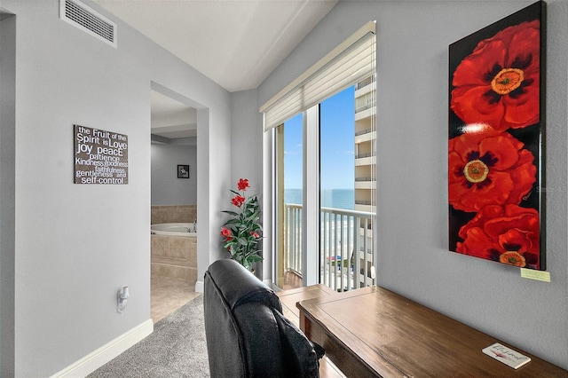 2901 S Atlantic Ave Unit 603, Daytona Beach Shores, FL 32118 - carpeted home office featuring a water view and baseboards