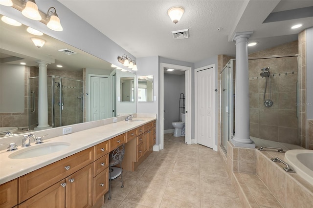 2901 S Atlantic Ave Unit 603, Daytona Beach Shores, FL 32118 - full bathroom featuring ornate columns, double vanity, a garden tub, and a shower stall