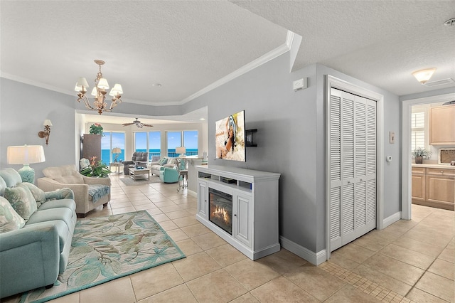 2901 S Atlantic Ave Unit 603, Daytona Beach Shores, FL 32118 - living area with a textured ceiling, light tile patterned flooring, healthy amount of natural light, a chandelier, and a ceiling fan