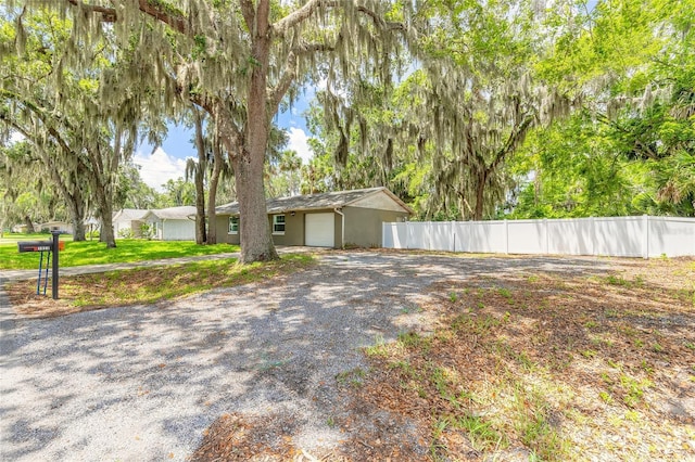 1624 Queen Palm Dr, Edgewater, FL 32132 - view of front of house featuring driveway, stucco siding, and an attached garage