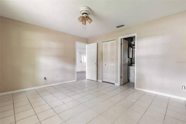 1624 Queen Palm Dr, Edgewater, FL 32132 - unfurnished bedroom with light tile patterned floors and ceiling fan