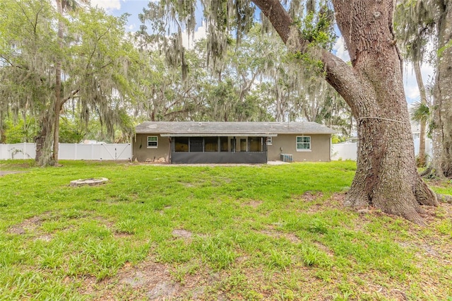 1624 Queen Palm Dr, Edgewater, FL 32132 - back of property featuring a sunroom, a fenced backyard, and stucco siding