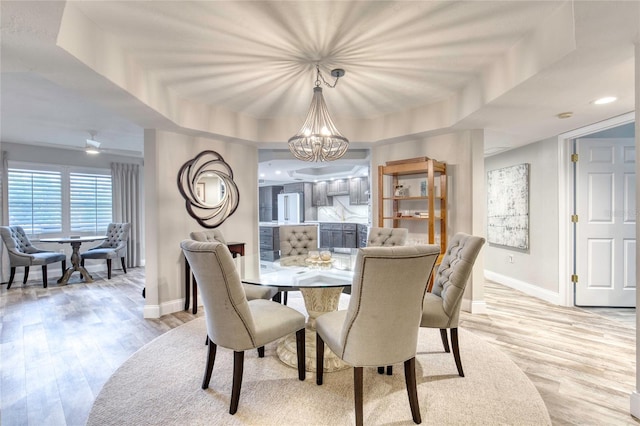 1 John Anderson Dr Unit 1030, Ormond Beach, FL 32176 - dining area featuring a chandelier, light wood-style floors, and a raised ceiling