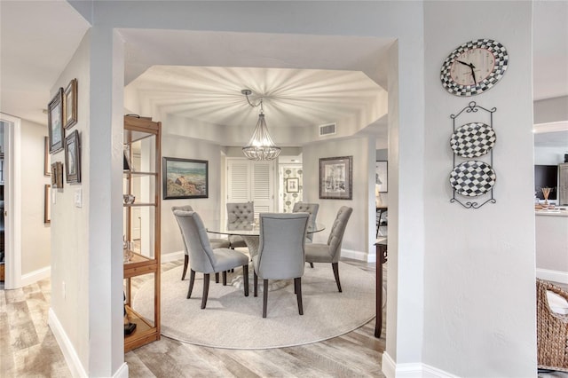1 John Anderson Dr Unit 1030, Ormond Beach, FL 32176 - dining room with a chandelier and light wood-style flooring