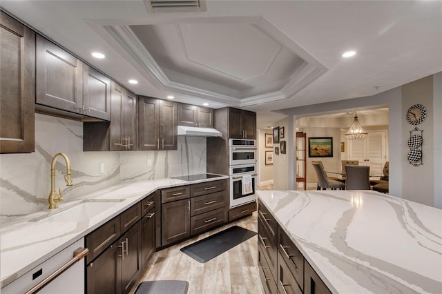 1 John Anderson Dr Unit 1030, Ormond Beach, FL 32176 - kitchen featuring light wood-style floors, dark brown cabinets, white appliances, light stone countertops, and recessed lighting