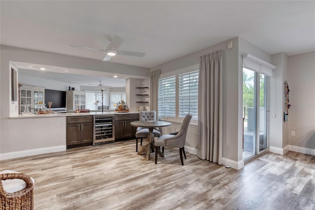 1 John Anderson Dr Unit 1030, Ormond Beach, FL 32176 - indoor bar featuring beverage cooler, light wood-type flooring, and a ceiling fan