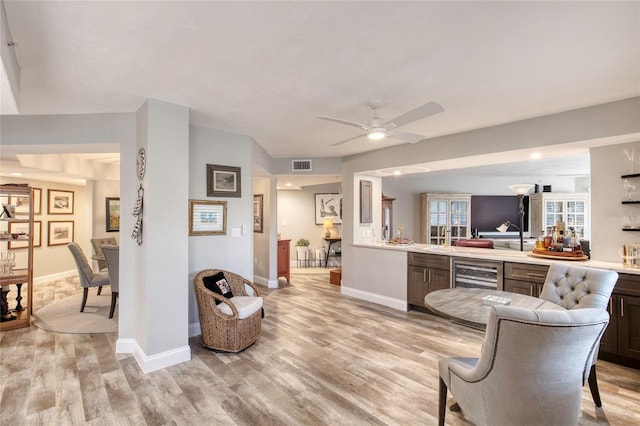 1 John Anderson Dr Unit 1030, Ormond Beach, FL 32176 - living area with light wood finished floors, beverage cooler, bar, and a ceiling fan