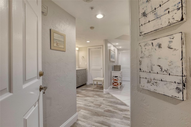 1 John Anderson Dr Unit 1030, Ormond Beach, FL 32176 - hall featuring a textured wall, light wood-style flooring, and recessed lighting