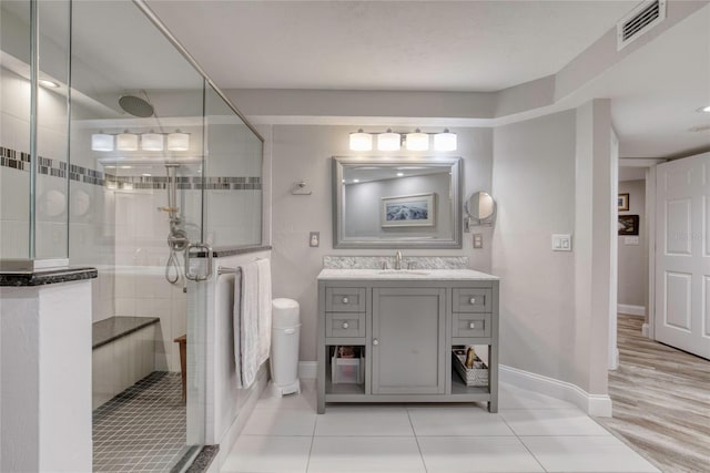 1 John Anderson Dr Unit 1030, Ormond Beach, FL 32176 - full bath featuring a stall shower, vanity, and tile patterned flooring