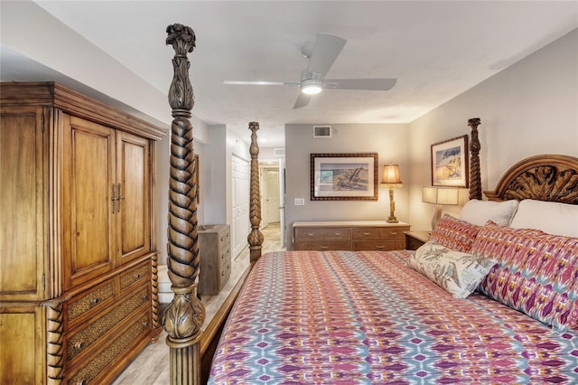 1 John Anderson Dr Unit 1030, Ormond Beach, FL 32176 - bedroom featuring a ceiling fan, connected bathroom, and light wood-type flooring