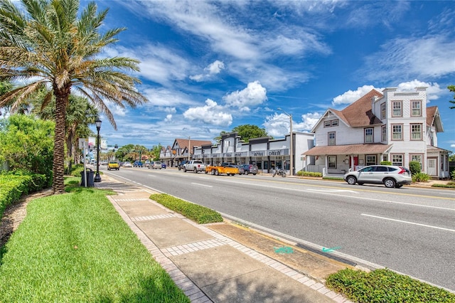 1 John Anderson Dr Unit 1030, Ormond Beach, FL 32176 - view of asphalt road featuring sidewalks, street lighting, and curbs