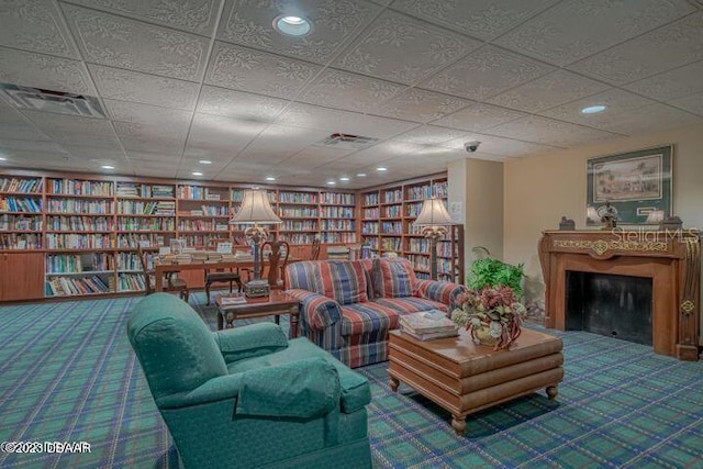 1 John Anderson Dr Unit 1030, Ormond Beach, FL 32176 - sitting room with carpet floors, bookshelves, recessed lighting, and a fireplace