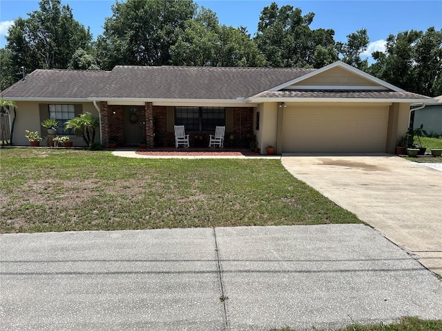 879 S Hancock Dr, Deltona, FL 32725 - ranch-style house featuring a garage, concrete driveway, and a front lawn