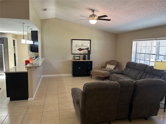 879 S Hancock Dr, Deltona, FL 32725 - living room with a textured ceiling, light tile patterned floors, vaulted ceiling, and ceiling fan