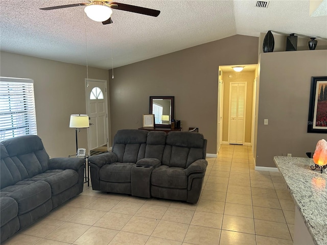 879 S Hancock Dr, Deltona, FL 32725 - living room with a ceiling fan, light tile patterned flooring, lofted ceiling, and a textured ceiling