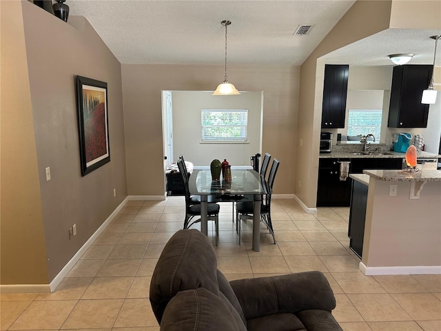 879 S Hancock Dr, Deltona, FL 32725 - dining room with light tile patterned floors and a textured ceiling