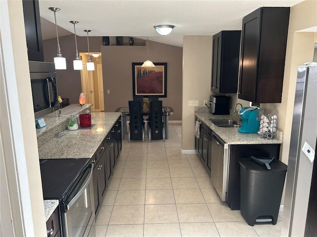 879 S Hancock Dr, Deltona, FL 32725 - kitchen featuring stainless steel appliances, light tile patterned flooring, dark cabinets, and pendant lighting