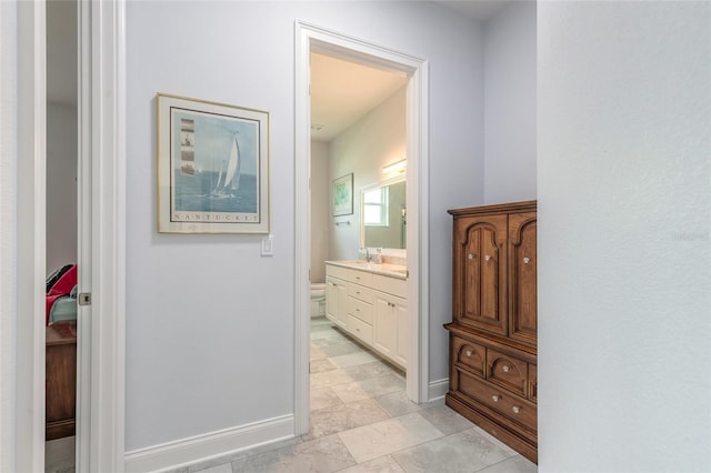 2816 E Venetian Lake Cir, New Smyrna Beach, FL 32168 - corridor with a sink and baseboards