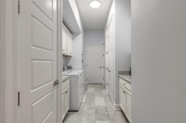 2816 E Venetian Lake Cir, New Smyrna Beach, FL 32168 - laundry area with cabinet space, washer and dryer, and light marble finish flooring