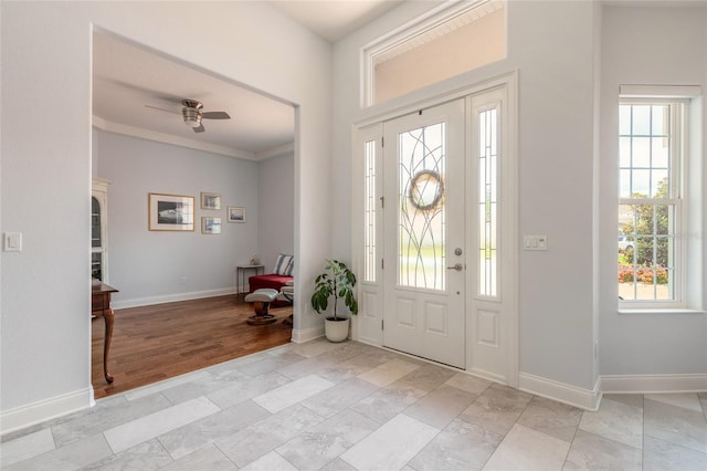 2816 E Venetian Lake Cir, New Smyrna Beach, FL 32168 - foyer featuring healthy amount of natural light, a ceiling fan, and crown molding