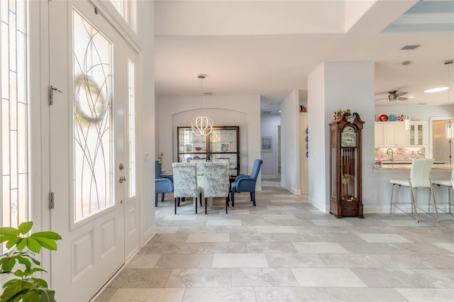 2816 E Venetian Lake Cir, New Smyrna Beach, FL 32168 - entrance foyer with ceiling fan and a chandelier