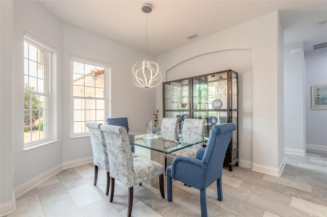 2816 E Venetian Lake Cir, New Smyrna Beach, FL 32168 - dining area with a chandelier and baseboards