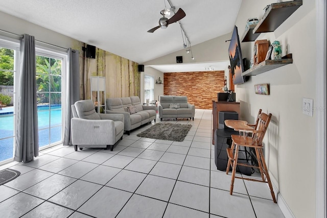 1366 Valhalla St, Deltona, FL 32725 - living area with plenty of natural light, a ceiling fan, lofted ceiling, an accent wall, and light tile patterned flooring
