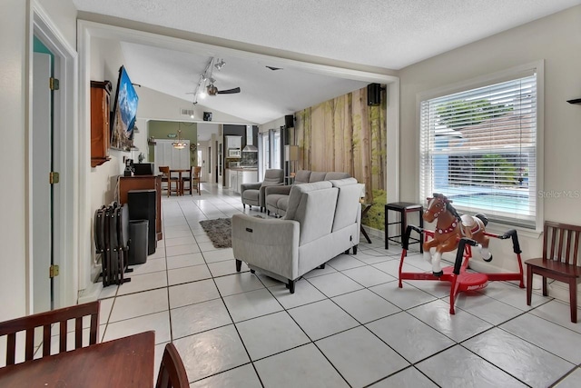 1366 Valhalla St, Deltona, FL 32725 - living area with lofted ceiling, ceiling fan, a textured ceiling, light tile patterned floors, and track lighting