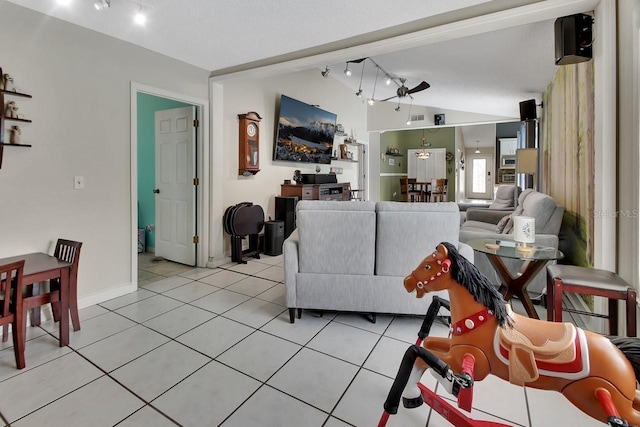 1366 Valhalla St, Deltona, FL 32725 - living room featuring vaulted ceiling, rail lighting, light tile patterned floors, and a ceiling fan