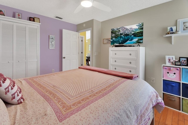 1366 Valhalla St, Deltona, FL 32725 - bedroom with wood finished floors, a closet, a ceiling fan, and a textured ceiling