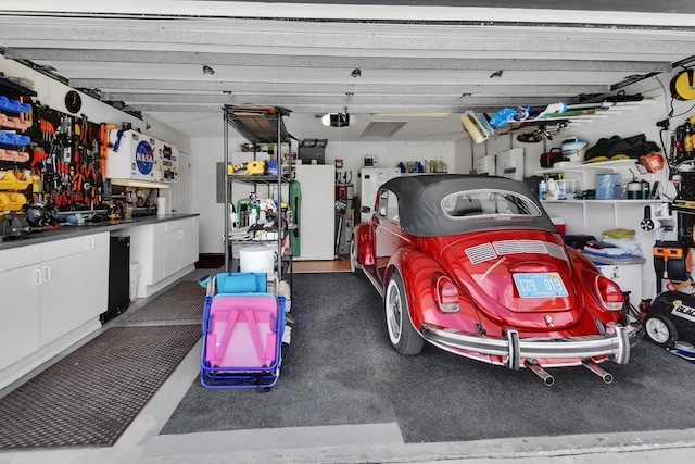 1366 Valhalla St, Deltona, FL 32725 - garage featuring a garage door opener and a workshop area