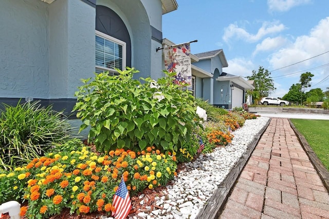 1366 Valhalla St, Deltona, FL 32725 - view of side of property with stucco siding and an attached garage