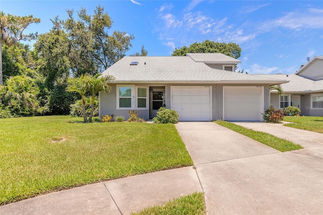 955 Grayling Ct Unit A, Port Orange, FL 32127 - view of front of property featuring a garage, a front yard, driveway, and a shingled roof