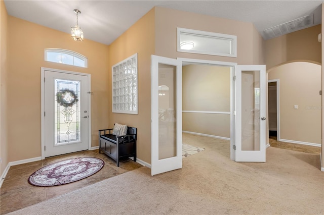 710 Grape Ivy Ln, New Smyrna Beach, FL 32168 - entryway with french doors, arched walkways, carpet floors, and a towering ceiling
