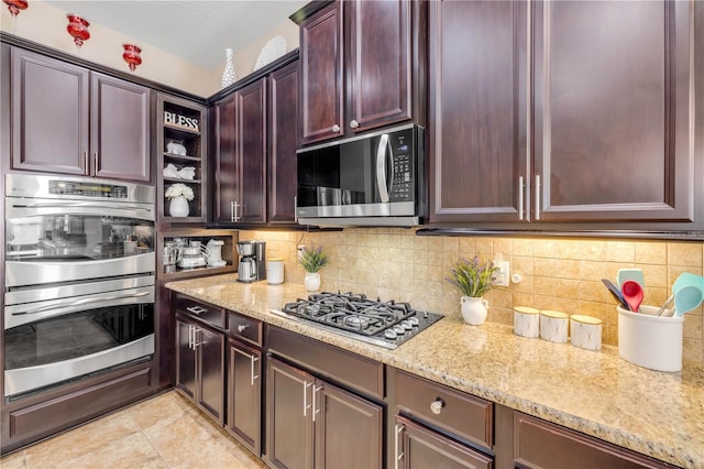 710 Grape Ivy Ln, New Smyrna Beach, FL 32168 - kitchen featuring appliances with stainless steel finishes, light stone countertops, decorative backsplash, and open shelves