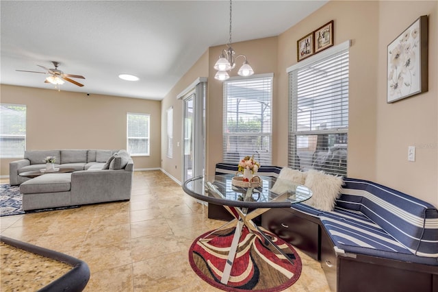 710 Grape Ivy Ln, New Smyrna Beach, FL 32168 - dining area featuring healthy amount of natural light, ceiling fan, light tile patterned floors, and a chandelier